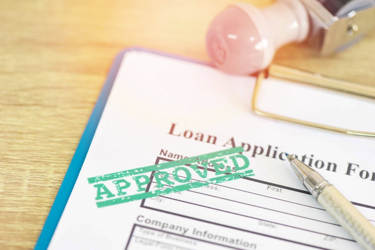 Loan application paperwork being reviewed and approved