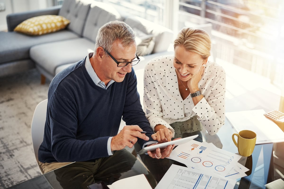 Couple reviewing their investment and savings documents together at home